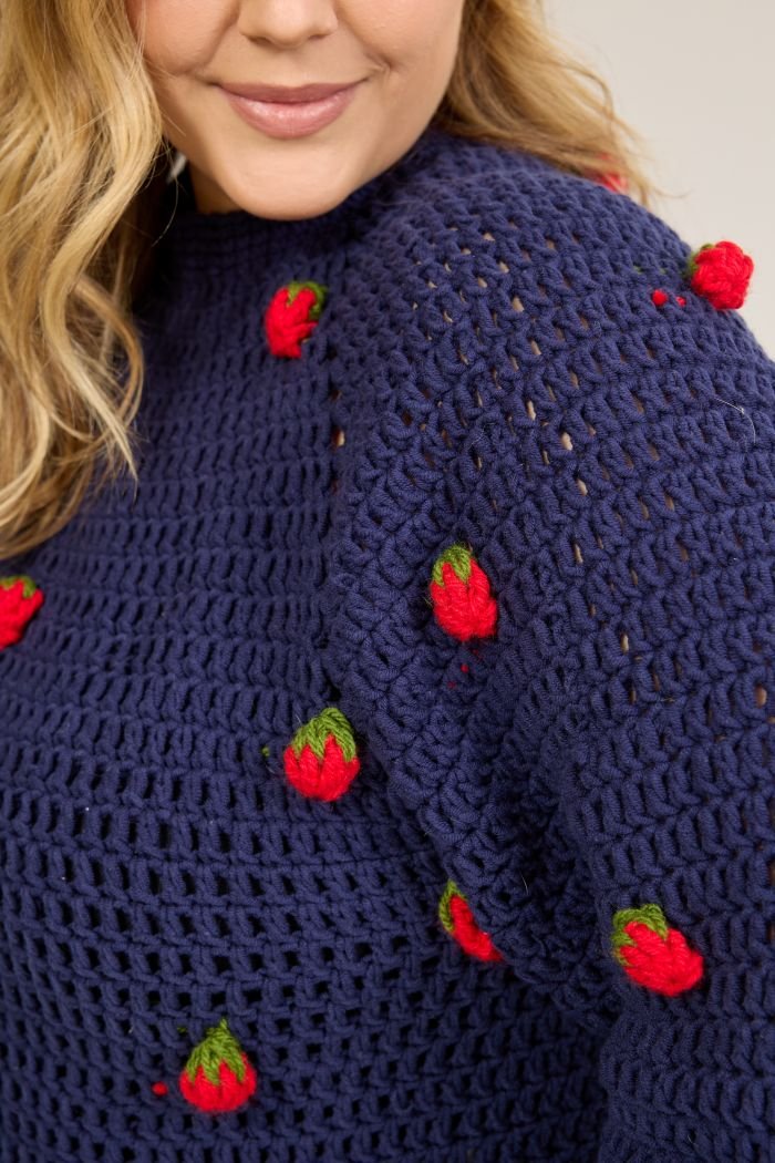 Detalhe dos morangos de crochê tridimensionais aplicados na Blusa Berry, feitos com Mollet nas cores Pimenta e Acelga