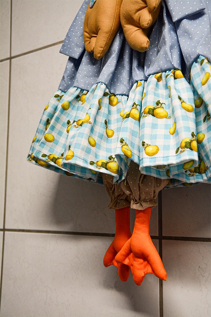Detalhe dos babados do puxa-saco Gansa Lina com tecido estampado de limões e patas laranjas